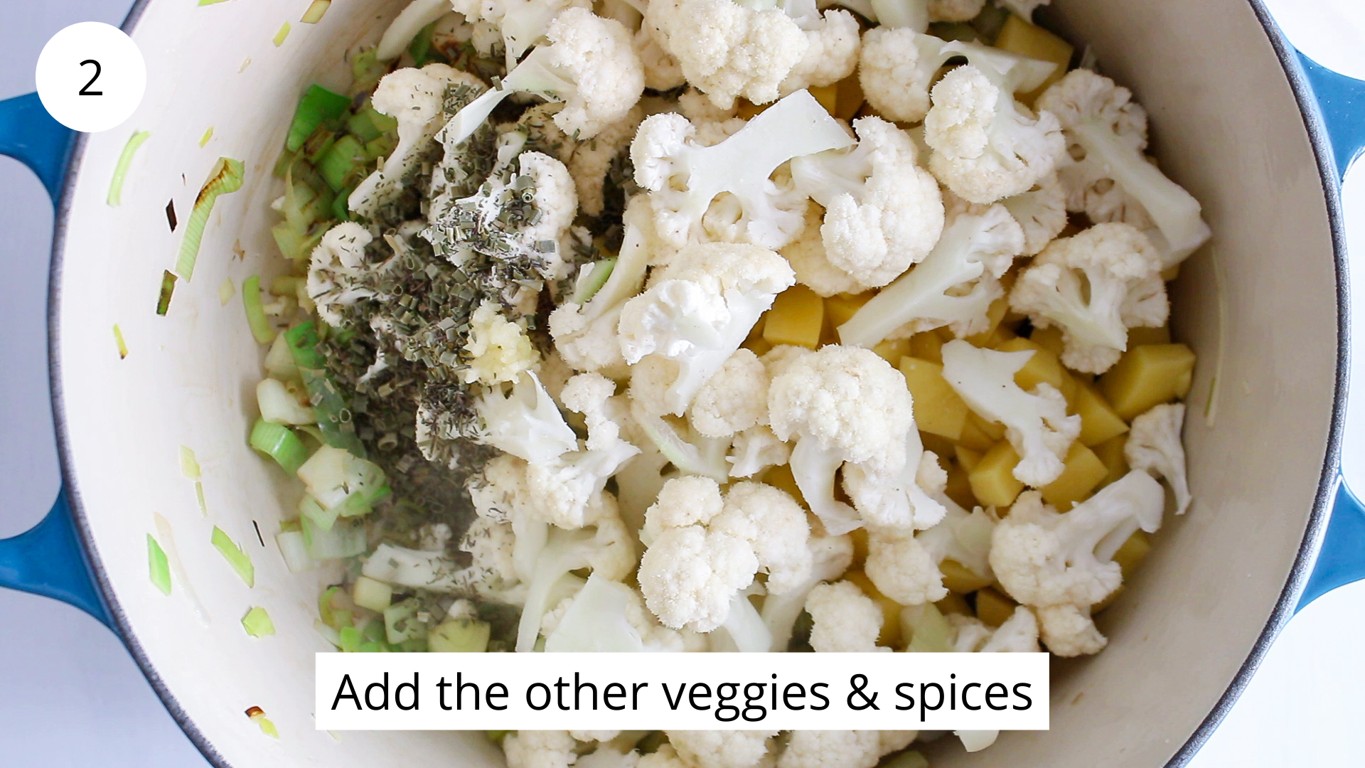 In process picture: Overhead view on a large pot filled with vegetables.