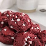Front angle view on a vegan red velvet cookies that's on top on many other cookies.