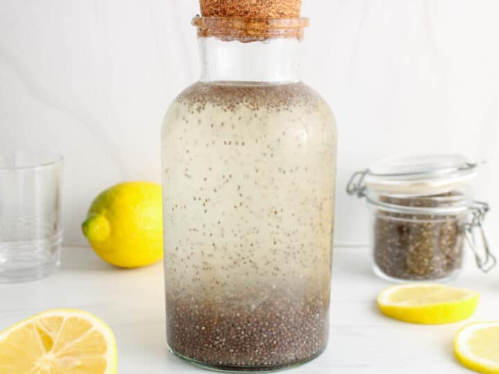 Close up on a large storing container filled with chia seed lemon water.