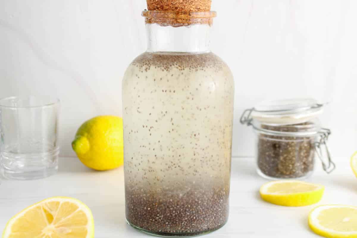 Close up on a large storing container filled with chia seed lemon water.