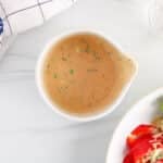 Overhead view on a small jar filled with a creamy cajun salad dressing.