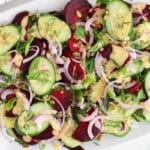 Over head view on a beet cucumber salad made with fresh dill and red onion with a creamy dijon dressing.