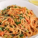 Front angle view on a bowl of harissa vegetable pasta.