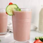 Front view on a dairy-free pink smoothie made with strawberries, cucumber and fresh mint.