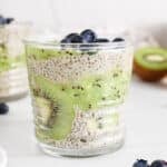 View on a kiwi chia pudding topped with blueberries.