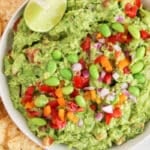 View on a bowl of creamy high-protein guacamole made using edamame.