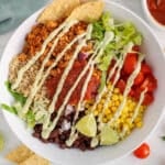 View on a vegan taco bowl drizzle with an avocado sauce.