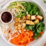 Overhead view on a vegan vermicelli tofu bowl served with a Vietnamese dressing.