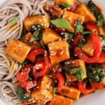 View on a bowl with a vegan Thai basil tofu served over noodles.