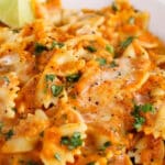 Close up on the creamy smooth tikka masala sauce from a bowl of pasta.