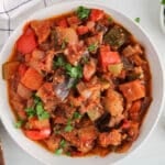 Overhead view on a bowl of Spanish pisto garnished with fresh parsley.