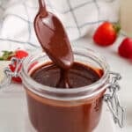 Close up on a vegan chocolate sauce with berries around.