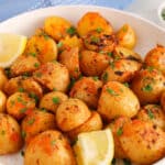 Front angle view on some oven baked harissa potatoes with lemon.