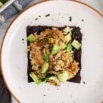 Overhead view on a square of vegan sushi bake over a nori sheet.