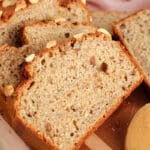 View on a sliced loaf of healthy peanut butter banana bread on a cutting board.