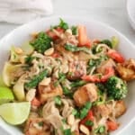 View on a bowl of vegan satay noodles with peanut sauce and tofu.