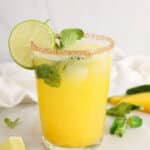 View on a healthy mango mocktail with a sweet and salty chili lime rim.