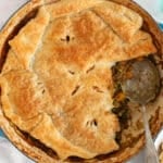 There is a portion taken off a large pan of vegan lentil pot pie.