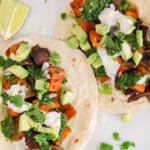 Close up on the filling ingredients of vegan sweet potato and mushroom tacos on a plate.