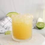 View on a short glass of non-alcoholic coconut water pineapple mocktail.