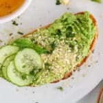 View on a high-protein avocado pea toast garnished with cucumber, hemp and mint.