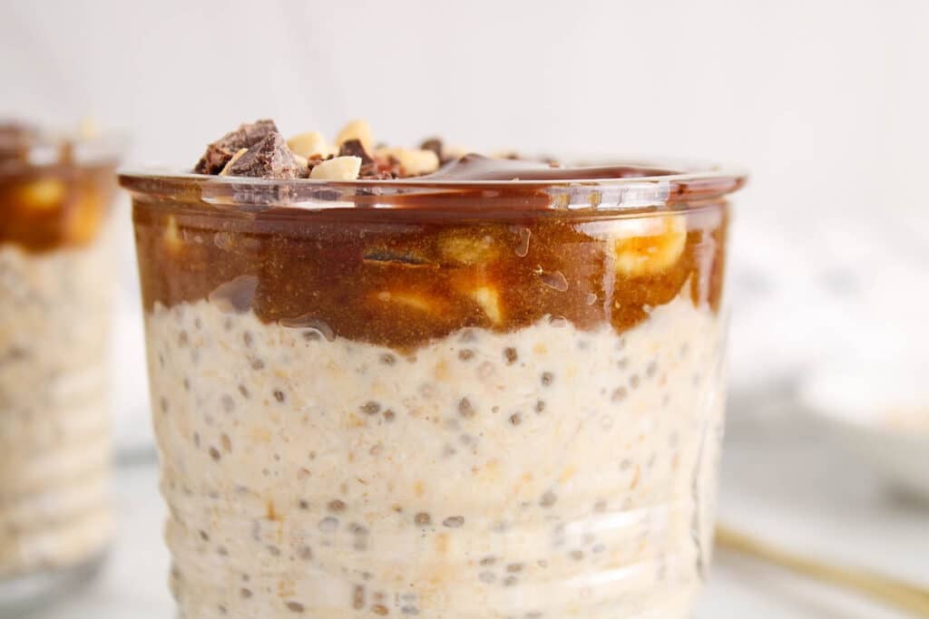 Close up on the date caramel and chocolate layers on a snickers overnight oats recipe.