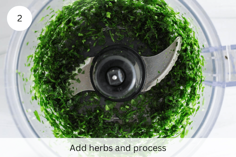 In process picture: chopped herbs in a food processor.