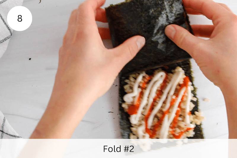 In process picture: fold the nori from top left to top right.