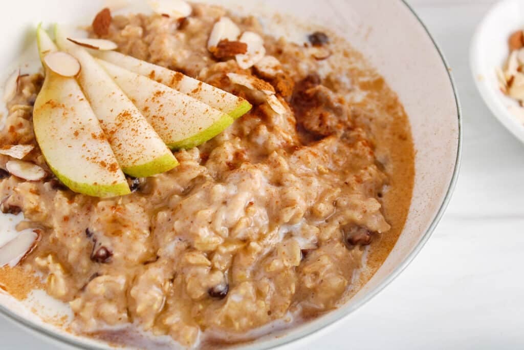 Close up on a creamy mixture of cinnamon spiced oatmeal in a bowl.