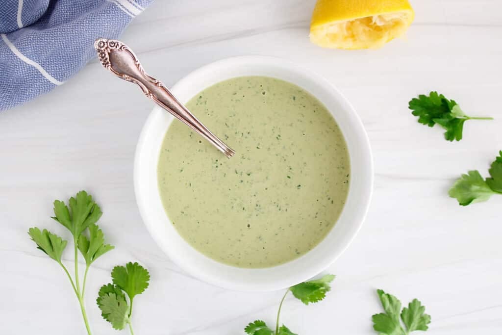 View on a bowl of lemon herb tahini dressing.