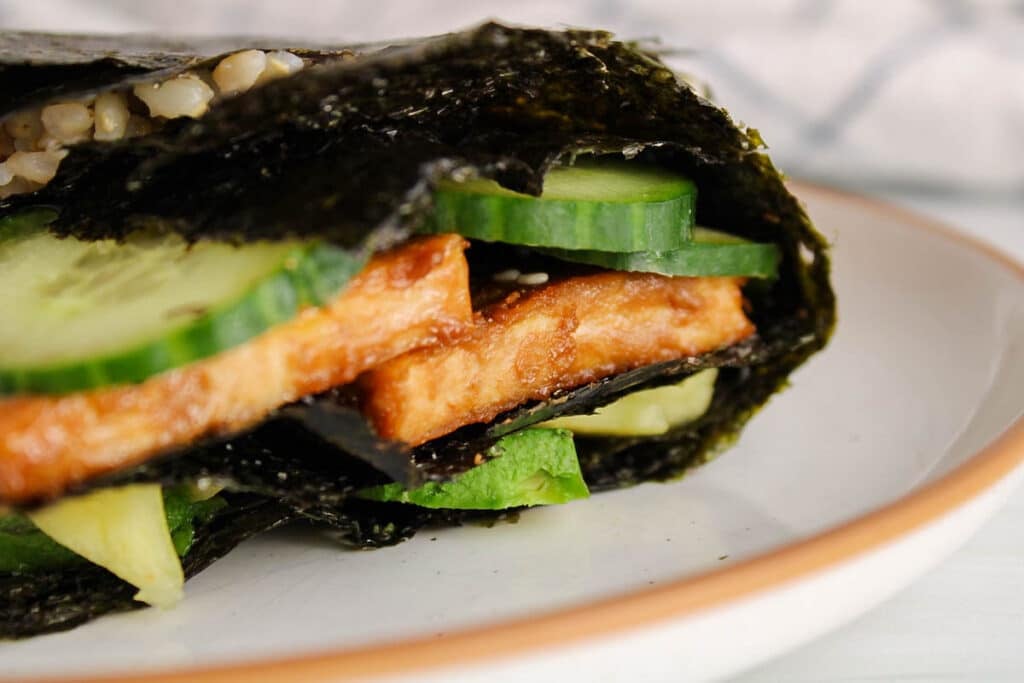 Focus on the marinated and pan fried tofu in a nori wrap.