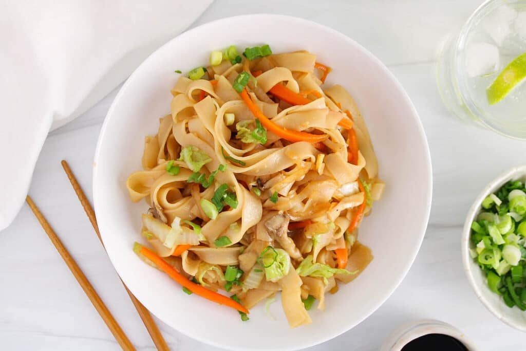 View on a bowl of Vietnamese stir-fried noodles with chopsticks.