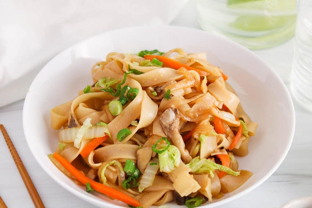 Front angle view on a bowl of Vietnamese stir-fried soy sauce noodles.