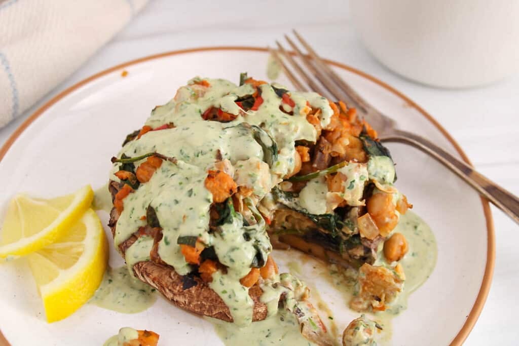 View on a vegan stuffed portobello mushroom with a bite taken off.