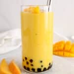 View on a tall glass of tropical mango smoothi boba.