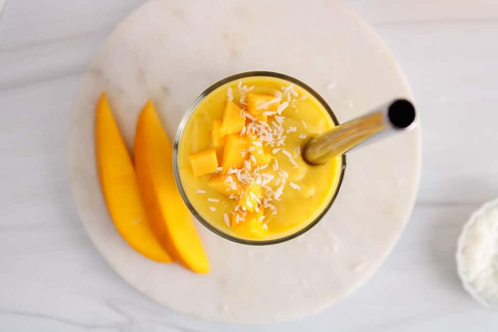 Overhead view on the topping over a glass of mango boba smoothie.