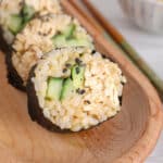 Close up on a vegan California sushi roll showing its tofu creamy filling.