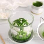 Matcha affogato over oat milk ice cream and garnished with white chocolate chips.