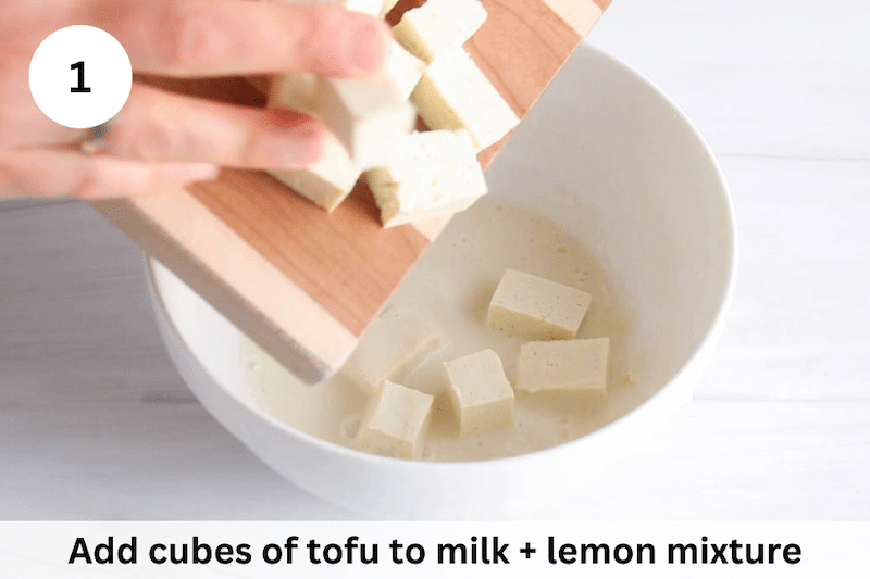 In process picture: add tofu to milk + lemon mix.