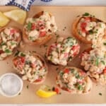 Vegan lemony white bean bruschetta bites on a board.