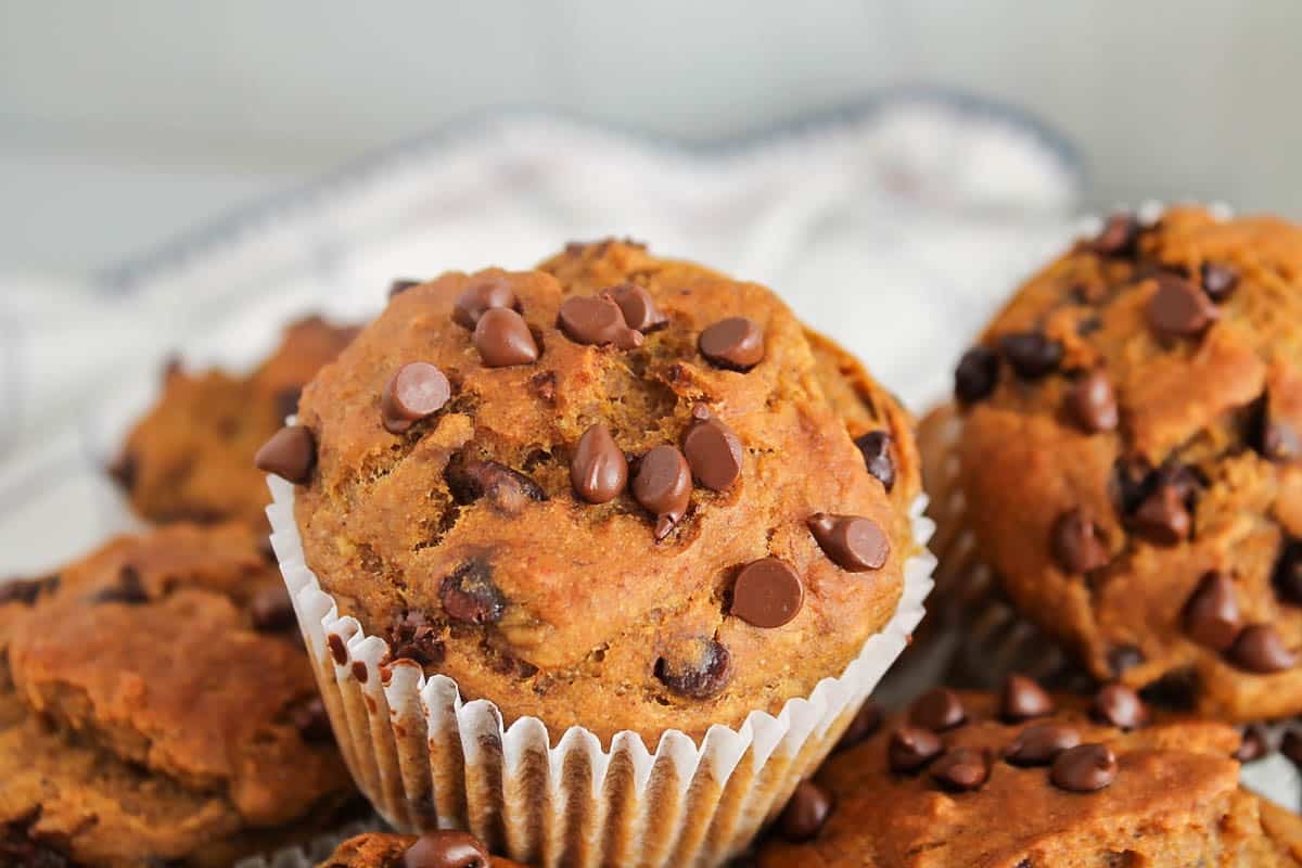 View on a vegan pumpkin banana muffins covered with chocolate chips.