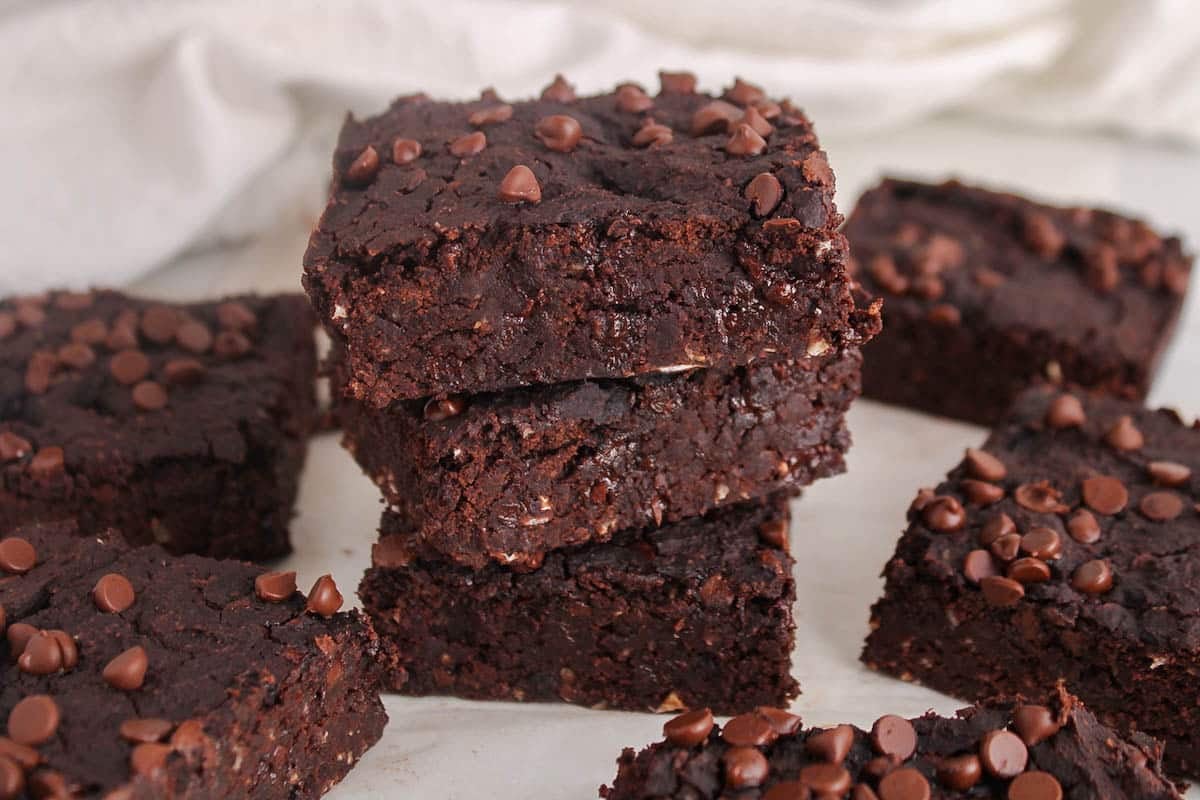 Squares of vegan kidney bean brownies over each other.