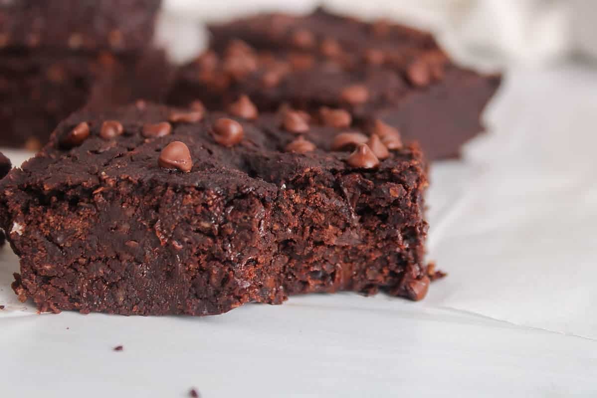 A bite taken from a square of vegan kidney bean brownie.