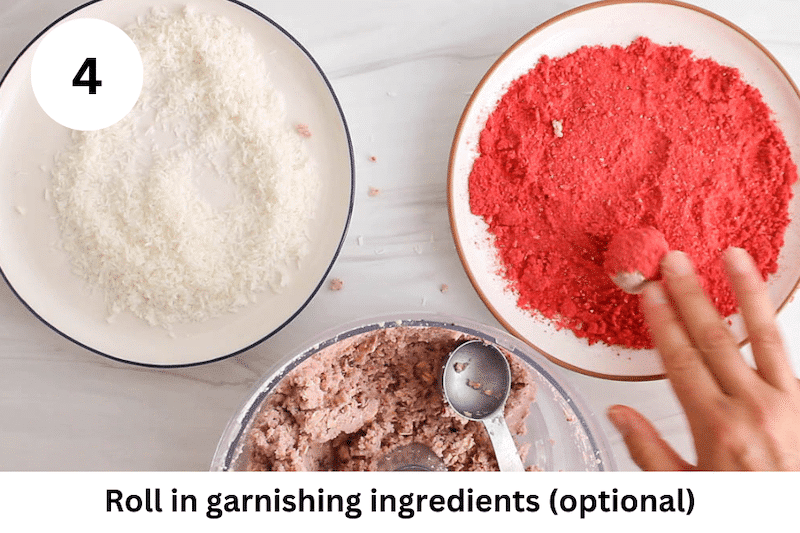 In process picture: rolling a bliss ball in a crushed freeze-dried strawberry mixture.