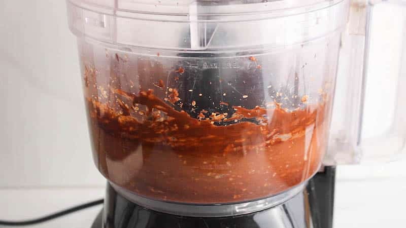 Food processor processing a chocolate creamy mixture.