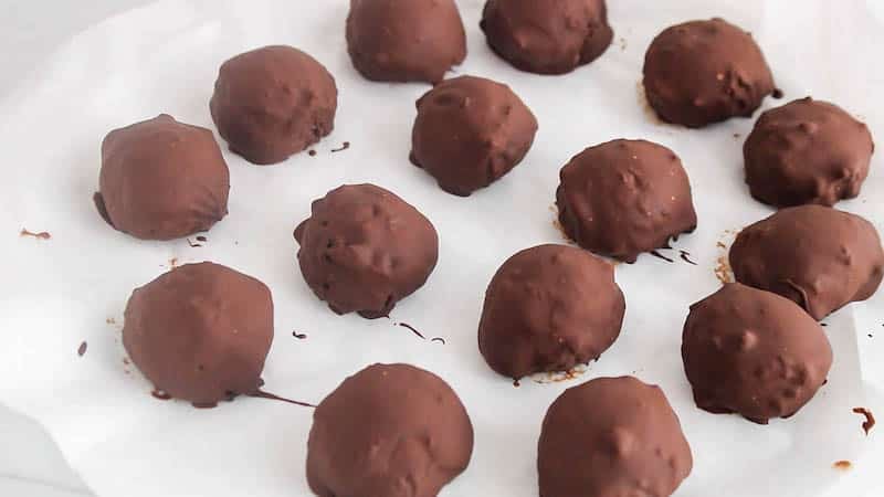 A few chickpea truffles setting on parchment paper.