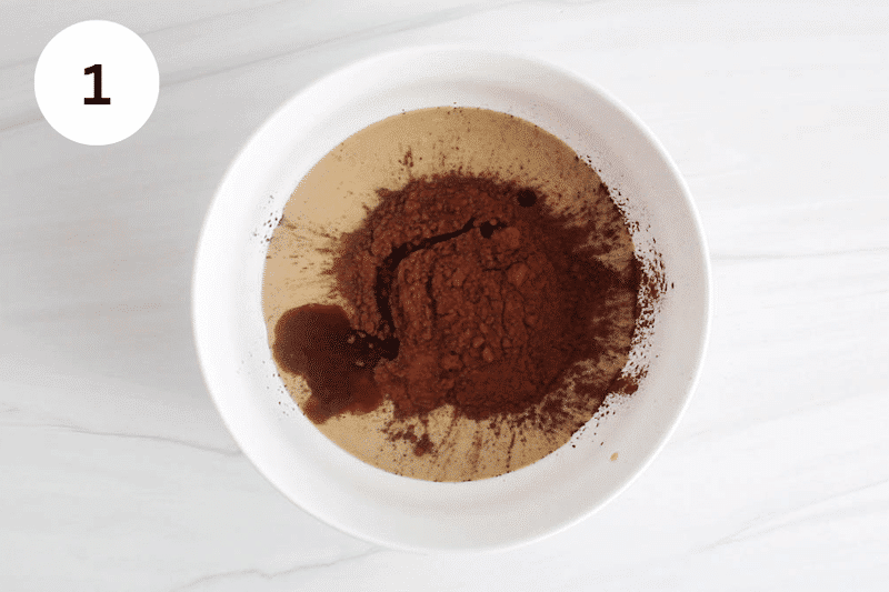 White bowl with tahini, maple syrup and cacao powder.