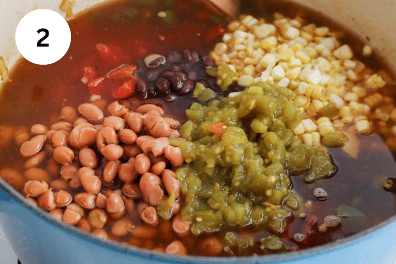 Large pot with broth, beans and vegetables.
