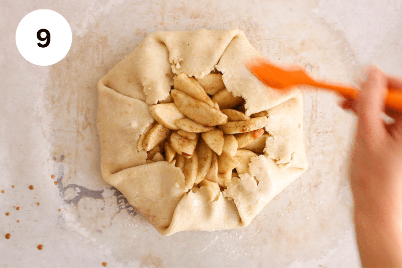 Brushing a galette with milk.