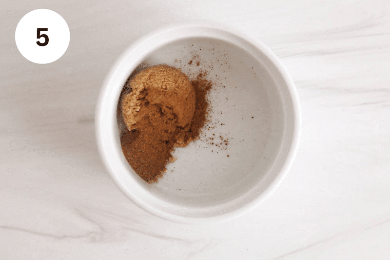 Brown sugar and cinnamon in a small white bowl.